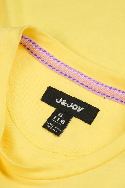 Yellow girl's T-shirt with decorative buttons on the shoulder