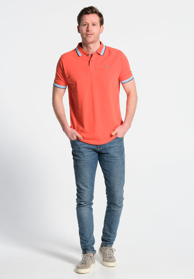 Men's coral polo shirt with pattern behind